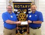 Josh Bryson hands a Rotary donation check to Highlands School Athletic Director Brett Lamb. The money was raised by the Rotary July 4th activities and will help improve the weight room at Highlands School.